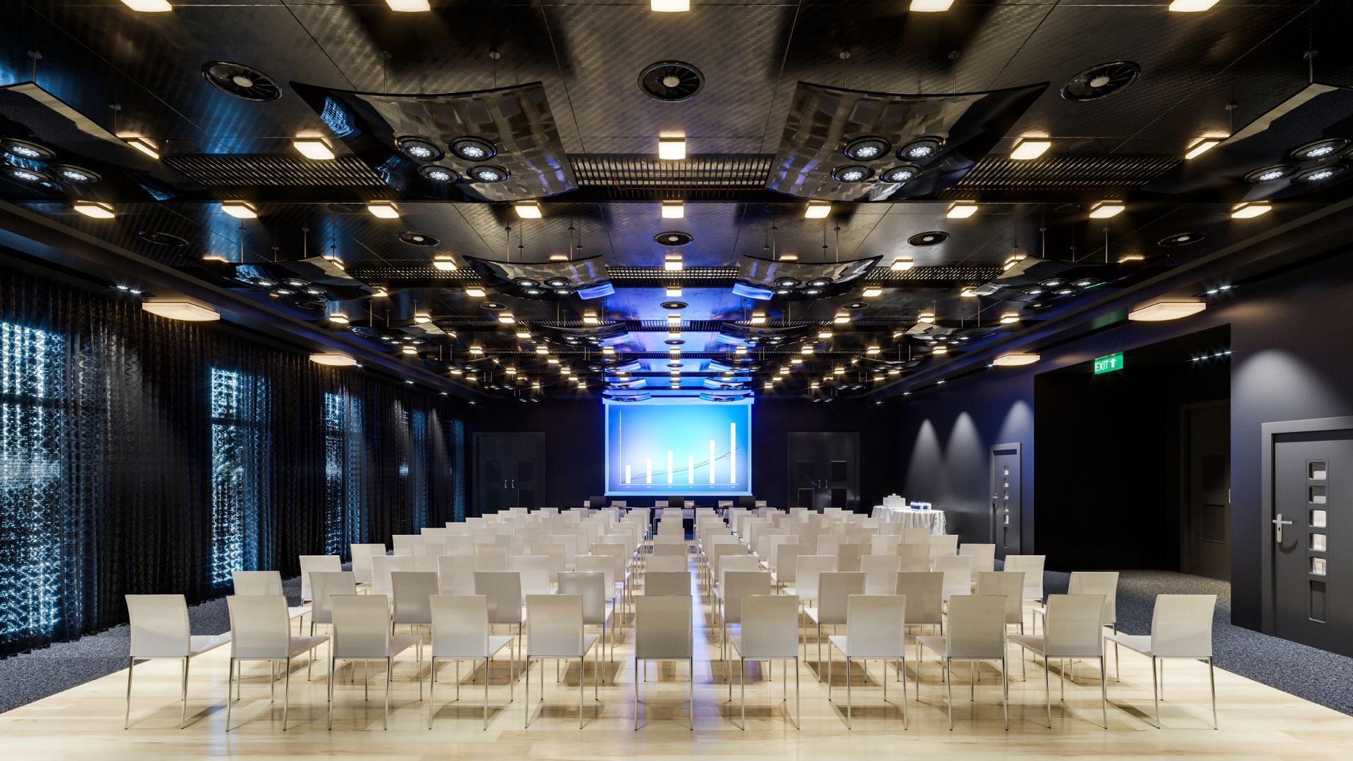 Typowy ośrodek konferencyjny z oświetloną sceną oraz miejscami siedzącymi na sali dla gości.